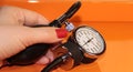 Tonometer in a woman`s hand with a manicure. A device for measuring pressure