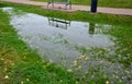 Too compact and impermeable soil does not absorb water during rains and floods. a lake was created in the park in the lawn, which Royalty Free Stock Photo