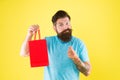 Too expensive. mature male beard with fashion purchase. sad hipster hold paperbag. Man with gift package. Buy product