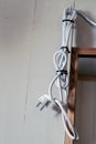 A too long powercord hanging on a bathroom wall next to a..mirror Royalty Free Stock Photo