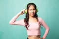 Too loud.  portrait of  young asian woman  holding  headphones and making unhappy face Royalty Free Stock Photo