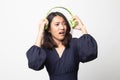 Too loud.  portrait of  young asian woman  holding  headphones and making unhappy face Royalty Free Stock Photo