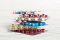 too many different pill cartridges stacked. selective Focus. Packs of blister pills with tablets. Colored pastilles Royalty Free Stock Photo