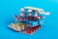 too many different pill cartridges stacked. selective Focus. Packs of blister pills with tablets. Colored pastilles Royalty Free Stock Photo