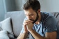 Unhappy young man holding his chin Royalty Free Stock Photo