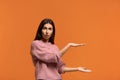 Too much. Photo of sbeautiful woman raises both palms, shapes something very big and wide, excited with huge size, measures huge Royalty Free Stock Photo