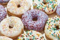 Too much sugar. Close up shot of assorted round glazed donuts with colorful sprinkles Royalty Free Stock Photo