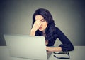 Too much work. Tired sleepy woman sitting at desk in front of laptop Royalty Free Stock Photo