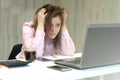 Too much work tired stressed woman sitting at her desk in front laptop computer. Busy schedule burnout workplace sleep deprivation Royalty Free Stock Photo