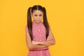 Too serious for her years. Serious school-aged child yellow background. School education Royalty Free Stock Photo