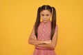 Too serious for her years. Serious school-aged child yellow background. School education Royalty Free Stock Photo