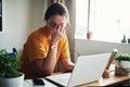 This is too stressful. an attractive young businesswoman sitting alone in her home office and feeling stressed while Royalty Free Stock Photo