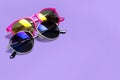 Too stylish fashionable sunglasses on a purple background. The concept of sun, summer, holidays, vacations, travel Royalty Free Stock Photo