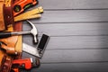 Tool belt with tools on wooden background Royalty Free Stock Photo