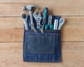 Tool belt with tools on wooden board background Royalty Free Stock Photo