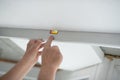 Tool level in men's hands and a flat horizontal surface of the ceiling. Styrofoam, seiling mounting. Royalty Free Stock Photo