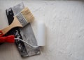 Tool for painting work. Spatula and brushes. Set of items for repair. Top view of a builder with a brush and spatula for applying