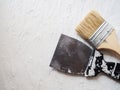 Tool for painting work. Spatula and brushes. Set of items for repair. Top view of a builder with a brush and spatula for applying