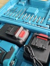 Tool set with drill bits and batteries arranged in a blue storage case Royalty Free Stock Photo
