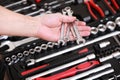 Tool store. Closeup of male hand holding wrenches. Auto repair kit in toolbox. Repairman instruments set. Inside the toolbox there Royalty Free Stock Photo