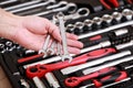 Tool store. Closeup of male hand holding wrenches. Auto repair kit in toolbox. Repairman instruments set. Inside the toolbox there Royalty Free Stock Photo