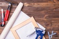 A tool for stretching canvas on a wooden stretcher. Forceps, a stapler for metal staples, a square wooden stretcher, a stationery