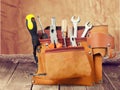 Tool belt with tools on wooden background Royalty Free Stock Photo