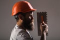 Tool, trowel, handyman, man builder. Mason tools, builder. Builders in hard hat, helmet. Bearded man worker, beard