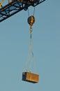 Toolbox hanging off a construction crane Royalty Free Stock Photo