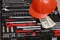 Toolbox, tools kit detail, dollar bills and orange protective helmet close up. instruments. set of tools. car tool kit. tool set Royalty Free Stock Photo