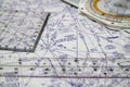 Tools for airplane pilots consisting of navigation computer, protractor, scale ruler against airway navigation chart in the