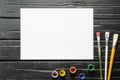 The tools of the artist, brushes, paints and canvas are not dark wooden background. Royalty Free Stock Photo
