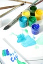 Tools of the artist: paints, brushes and a paper Royalty Free Stock Photo