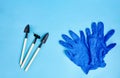 The tools and blue gloves or household equipment on blue background. Top view. Space for text Royalty Free Stock Photo