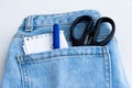 Tools in a blue jeans pocket on white background