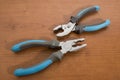 Tools, blue pliers on a walnut table Royalty Free Stock Photo