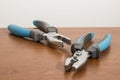 Tools, blue pliers on a walnut table Royalty Free Stock Photo