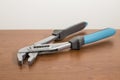 Tools, blue pliers on a walnut table Royalty Free Stock Photo