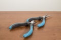 Tools, blue pliers on a walnut table Royalty Free Stock Photo
