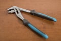 Tools, blue pliers on a walnut table Royalty Free Stock Photo