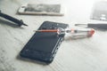 Tools with broken phones on table