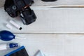 Tools for cleaning camera with dslr camera on white wood background. Royalty Free Stock Photo