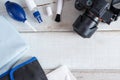 Tools for cleaning camera with dslr camera on white wood background. Royalty Free Stock Photo