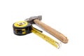Tools collection - old tape measure and hammer Royalty Free Stock Photo