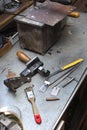 Tools, components and finished mold lie on a bench in the handcraft.