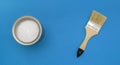 Tools for construction and decoration. A paintbrush and a metal can of paint. Bright background, top view Royalty Free Stock Photo