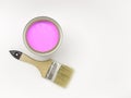 Tools for construction and decoration. Paintbrush next to a can of pink paint on a white background, top view, free space for text Royalty Free Stock Photo