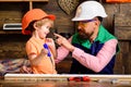 Tools construction. Father teaching little son to use carpenter tools and hammering. Father helping son at workshop. Royalty Free Stock Photo