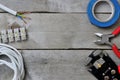 Tools for electricians on a wooden background.