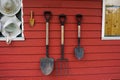 Tools and equipments farm gardening on red wooden wall of barn farmhouse for farmer use growing cultivating horticulture at meadow Royalty Free Stock Photo